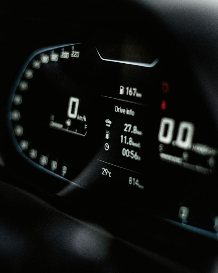 about-04 Close-up of a sleek digital car dashboard displaying speed and drive info.