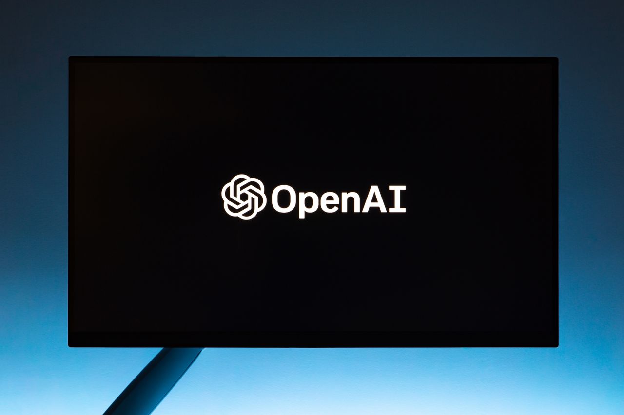 project-02-a Minimalist display of OpenAI logo on a screen, set against a gradient blue background.